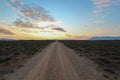 Long straight dirt road at sunset in Camdeboo National Park Royalty Free Stock Photo